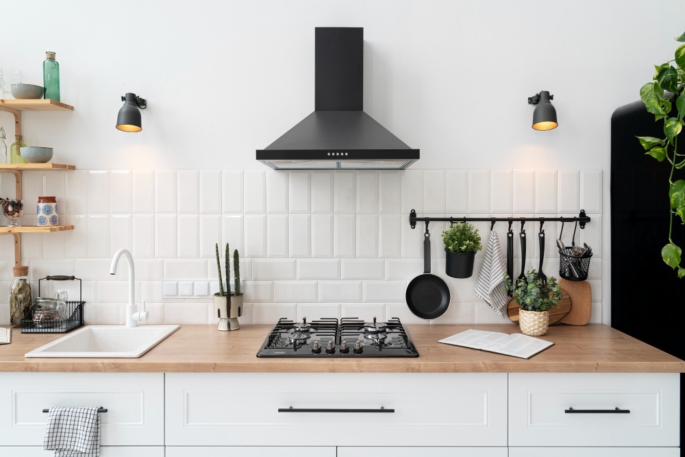 Modern white kitchen design with wooden countertops and black accents by a professional kitchen remodeling contractor in NJ